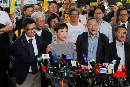 Pro-democracy activist Chan Kin-man pats fellow activist Tanya Chan's shoulders as she speaks to the media before a verdict on their involvement in the Occupy Central, also known as "Umbrella Movement" , in Hong Kong, China April 9, 2019. REUTERS/Tyrone Siu TPX IMAGES OF THE DAY