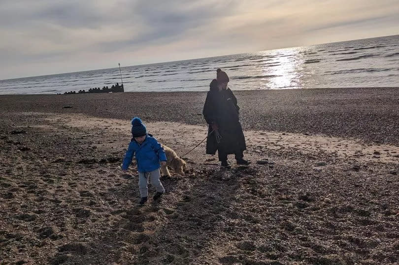 A family and their dog on a beach