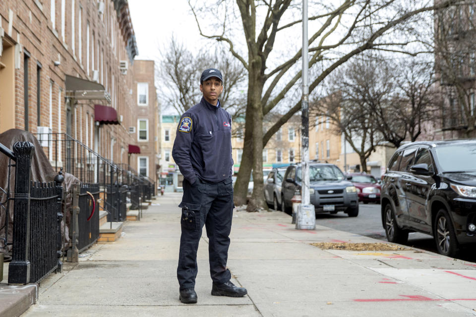 In this Saturday, April 4, 2020 photo, emergency medical technician Josh Allert poses for a photo in New York. Thousands of workers have been thrust onto the front lines of the coronavirus emergency in New York City. That includes Allert, whose days are a blur and a battle. (AP Photo/Mary Altaffer)