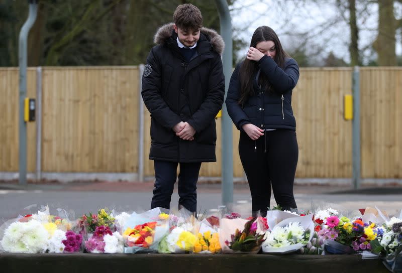 People look at flowers left near to the residence of Captain Sir Tom Moore, after his family announced that the centenarian fundraiser died, in Marston Moretaine near Milton Keynes