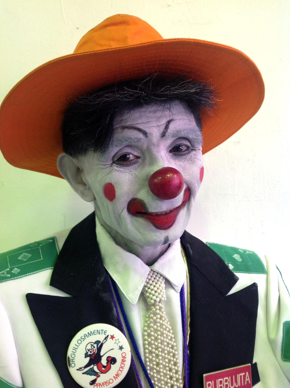 In this Monday, Oct. 22, 2012 photo, whiteface clown Burbujita poses for a photo during Mexico's 17th annual clown convention, La Feria de la Risa, in Mexico City. Approximately 500 clowns gathered at two local theaters in the capital city to exchange ideas, compete for laughs and show off their comedy performances. (AP Photo/Anita Baca)