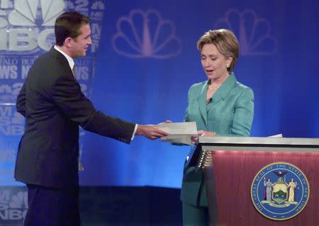 Rick Lazio walks over and challenges Hillary Clinton to sign a Freedom from soft money pact during their first 2000 Senatorial Debate in Buffalo. REUTERS/Richard Drew/Pool