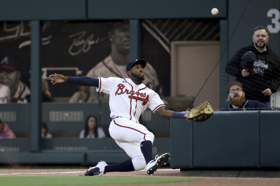 Atlanta Braves right fielder Travis Demeritte makes a sliding catch to get out Chicago Cubs' Yan Gomes during the fourth inning of a baseball game at Truist Park Tuesday, April 26, 2022, in Atlanta. (Jason Getz/Atlanta Journal-Constitution via AP)