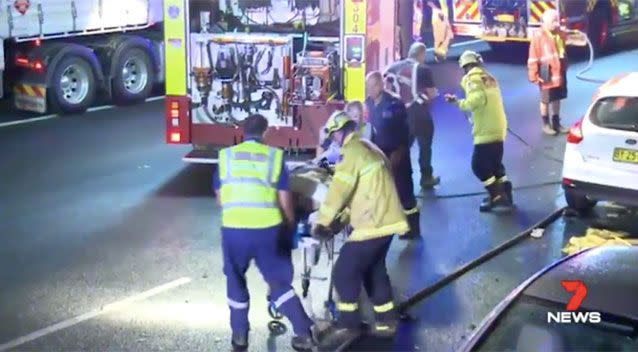 Emergency crews transported one of the injured on the stretcher. Source: 7 News