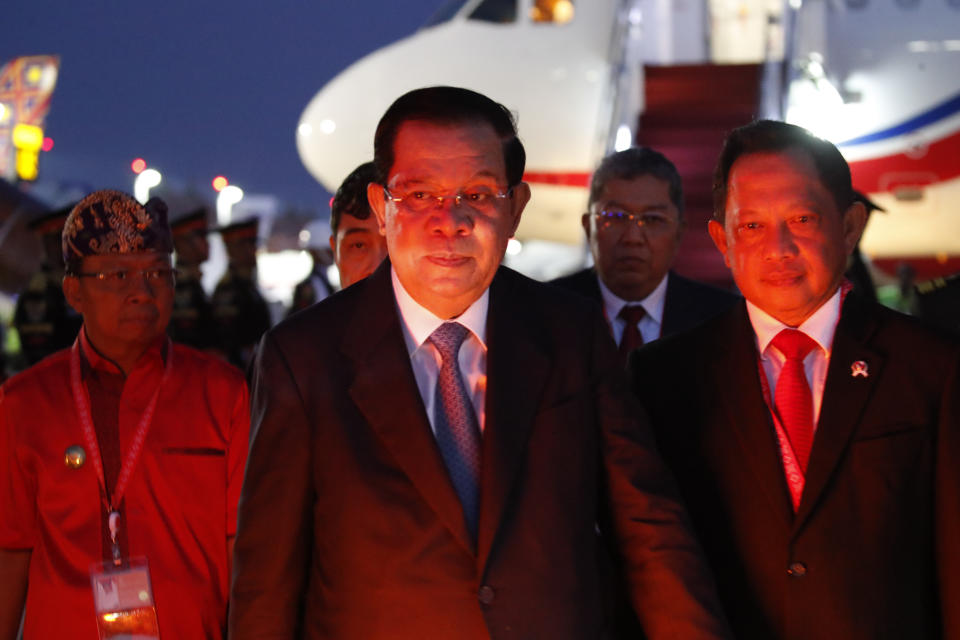 Cambodia's Prime Minister Hun Sen, center, arrives at Ngurah Rai International Airport ahead of the G20 Summit in Bali, Indonesia Nov. 14, 2022. Hun Sen tested positive for COVID-19 at G-20, Monday, Nov. 14, days after hosting world leaders at summit in Phnom Penh. (Ajeng Dinar Ulfiana/Pool Photo via AP)