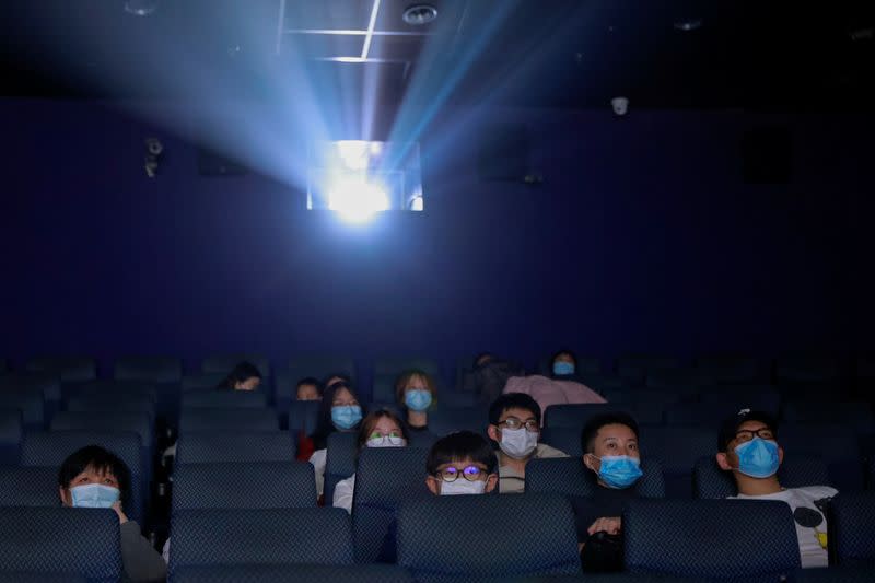 People watch the Chinese documentary "Days and Nights in Wuhan" following the outbreak of the coronavirus disease (COVID-19) at a cinema in Beijing