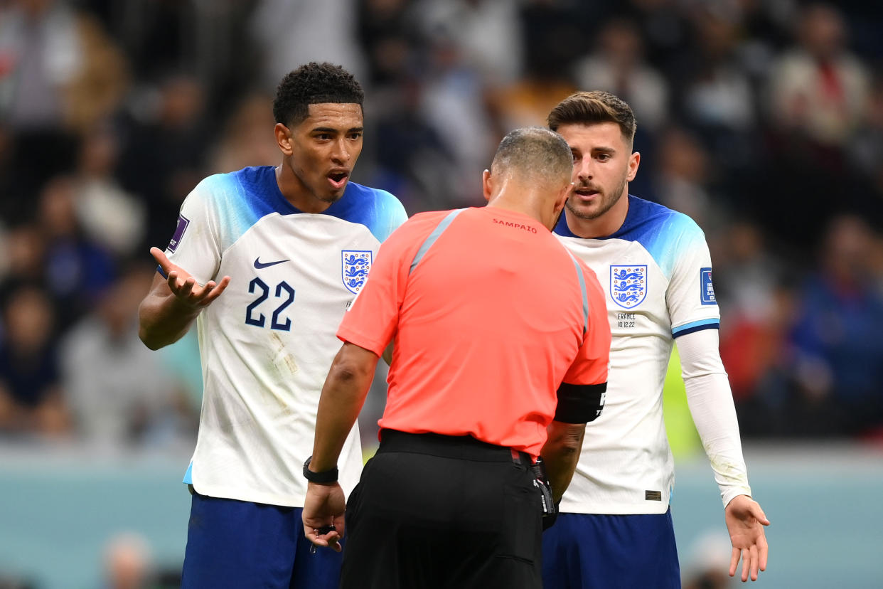 AL KHOR, QATAR - DECEMBER 10: Referee Wilton Sampaio is protested by Jude Bellingham and Mason Mount of England after a possible penalty incident leading to the video assistant referee review during the FIFA World Cup Qatar 2022 quarter final match between England and France at Al Bayt Stadium on December 10, 2022 in Al Khor, Qatar. (Photo by Shaun Botterill - FIFA/FIFA via Getty Images)