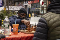 Tunde Onakoya, 29, a Nigerian chess champion and child education advocate, plays a chess game in Times Square, Friday, April 19, 2024 in New York. (AP Photo/Yuki Iwamura)