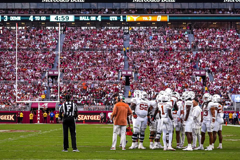 Texas players gather in a huddle during a timeout in last September's win over Alabama at Bryant-Denny Stadium in Tuscaloosa. The move to the SEC will make marquee matchups more common for Texas, which faces Georgia, Oklahoma, Florida and Texas A&M in conference this year as well as a nonconference showdown at Michigan.