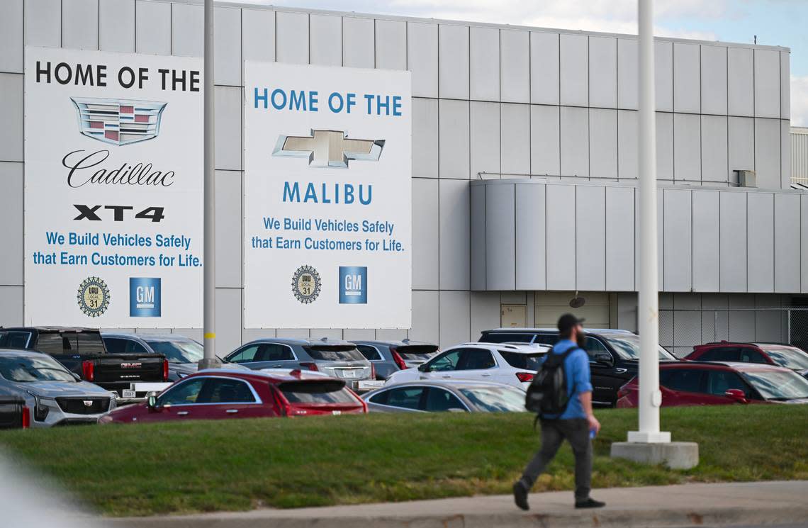 A person walks outside of General Motors’ assembly plant on Wednesday, Sept. 20, 2023, in Kansas City, Kan. General Motors announced layoffs Wednesday, citing supply chain issues due to United Auto Workers striking in its St. Louis plant.