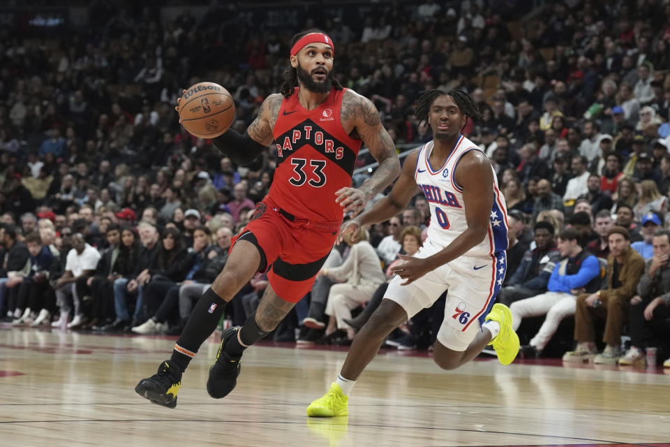 Toronto Raptors' Gary Trent Jr. drives past Philadelphia 76ers' Tyrese Maxey during the first half of an NBA basketball game Saturday, Oct. 28, 2023, in Toronto. (Chris Young/The Canadian Press via AP)