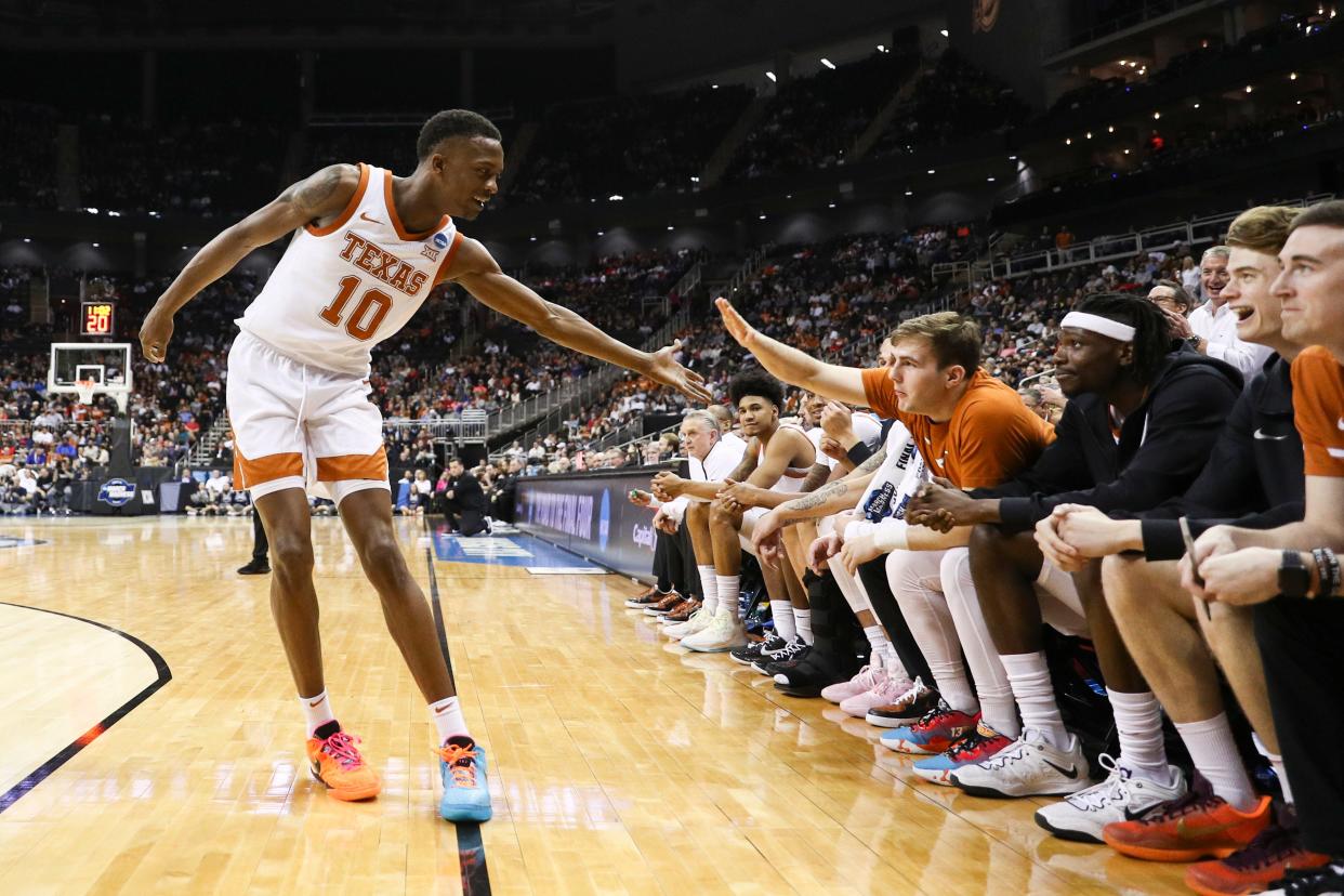 Texas guard Jabari Rice celebrates with his team after drawing a foul in the second half of Friday night's NCAA Midwest Regional semifinal against Xavier. Texas cruised to an 83-71 victory and into an Elite Eight matchup with Miami on Sunday.