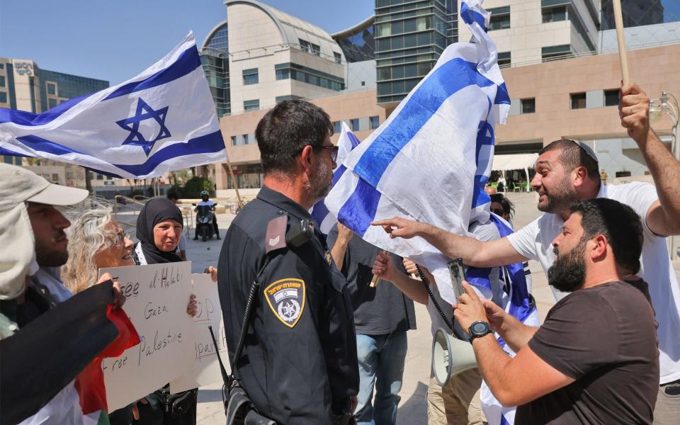 Protesters representing both sides of the trial clash outside the court hearing - Ahmas Gharabli/AFP via Getty Images