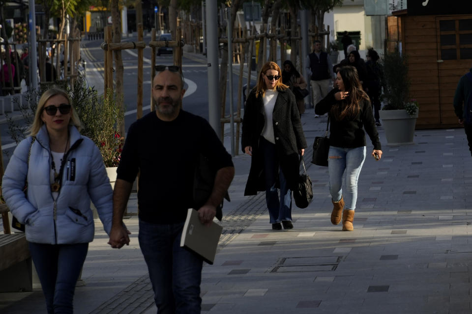 People walk at Makarios III street, a main shopping street, in central capital Nicosia, Cyprus, Wednesday, Jan. 24, 2024. Official figures show Cyprus making significant headway in weaning itself off Russian cash and business as it tries to clean up its image as a favorite destination for Moscow's money. According to the figures, the number of Russian clients using Cypriot banks has dropped 82% between 2014 up until the end of 2022. (AP Photo/Petros Karadjias)