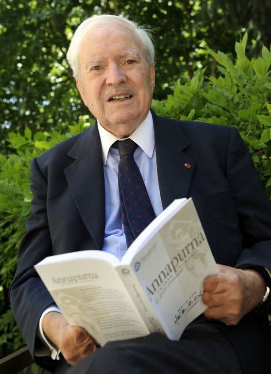 French climber Maurice Herzog, pictured on June 23, 2010 in Madrid, with his book on his Annapurna expedition. Herzog, who conquered Annapurna in the first recorded ascent of a peak above 8,000 metres, has died at the age of 93