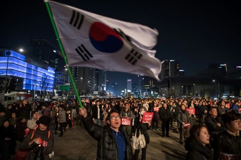 Anti-government protesters take part in a march in the South Korean capital Seoul on March 4, 2017