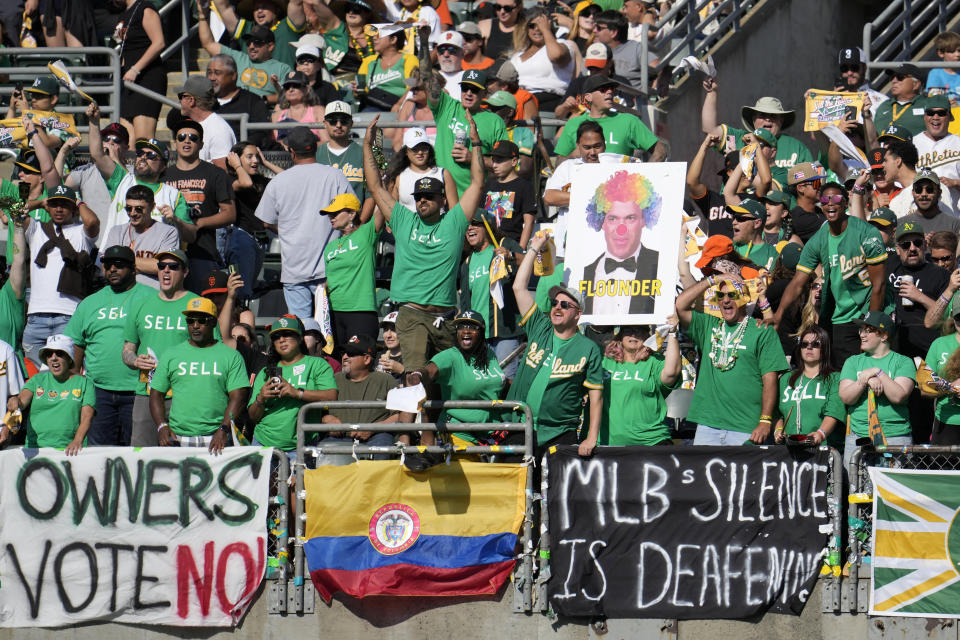 FILE - Oakland Athletics fans in right field yell behind signs protesting the team's potential move to Las Vegas and to call for managment to sell the team during the fifth inning of a baseball game between the Athletics and the San Francisco Giants in Oakland, Calif., Saturday, Aug. 5, 2023. Major League Baseball team owners are set to vote Thursday, Nov. 16, on the proposed relocation of the Oakland Athletics to Las Vegas at the end of their league-wide meeting.(AP Photo/Jeff Chiu, File)