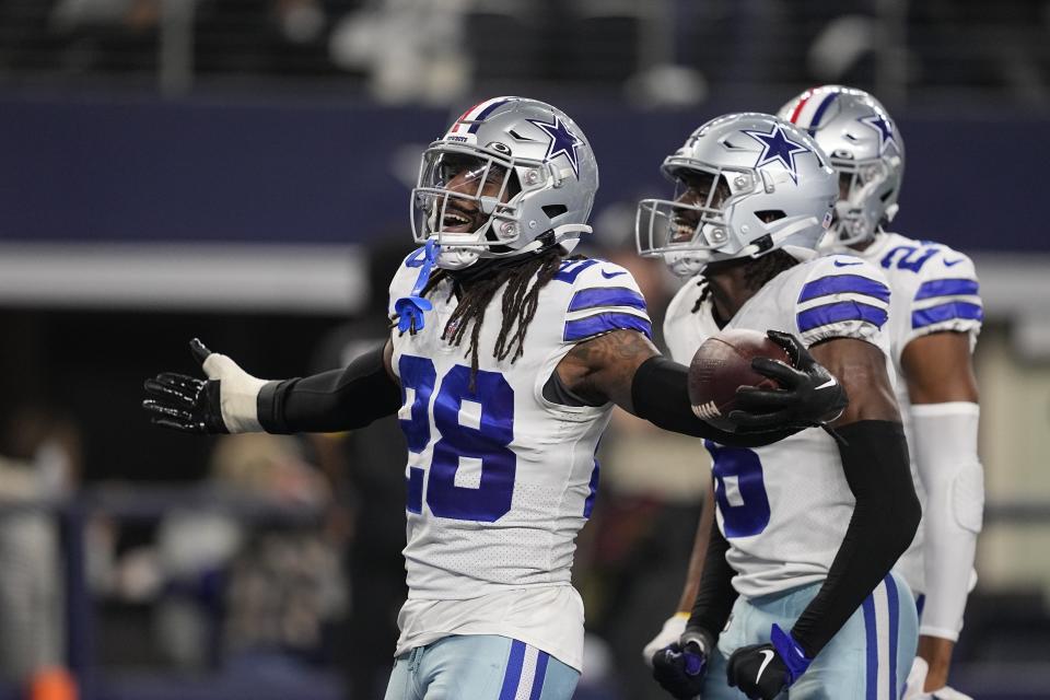 Dallas Cowboys' Malik Hooker (28) celebrates after an interception during the first half of an NFL football game against the Indianapolis Colts, Sunday, Dec. 4, 2022, in Arlington, Texas. (AP Photo/Tony Gutierrez)