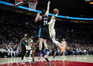Golden State Warriors guard Donte DiVincenzo, right, heads for a dunk against Portland Trail Blazers forward Drew Eubanks during the first half of an NBA basketball game in Portland, Ore., Wednesday, Feb. 8, 2023. (AP Photo/Craig Mitchelldyer)