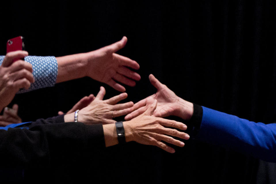 Hillary shakes hands in Wilmington