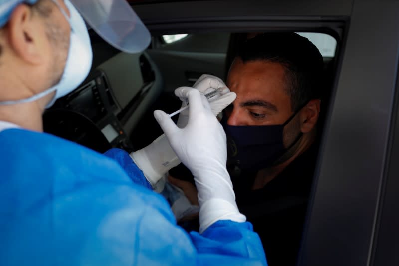 A plastic surgeon conducts drive-through Botox injections in the garage of his clinic in Miami