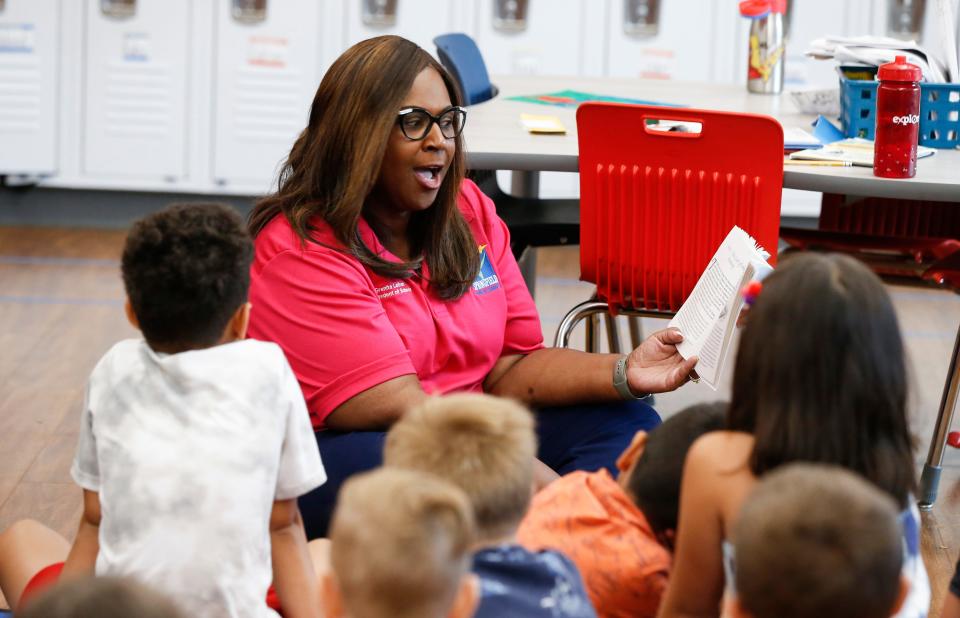 Superintendent Grenita Lathan reads a book to children in a summer school class at Sunshine Elementary in July.