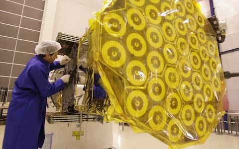 A European Space Agency technician works on the Giove B satellite in Noordwijk - Credit: AFP