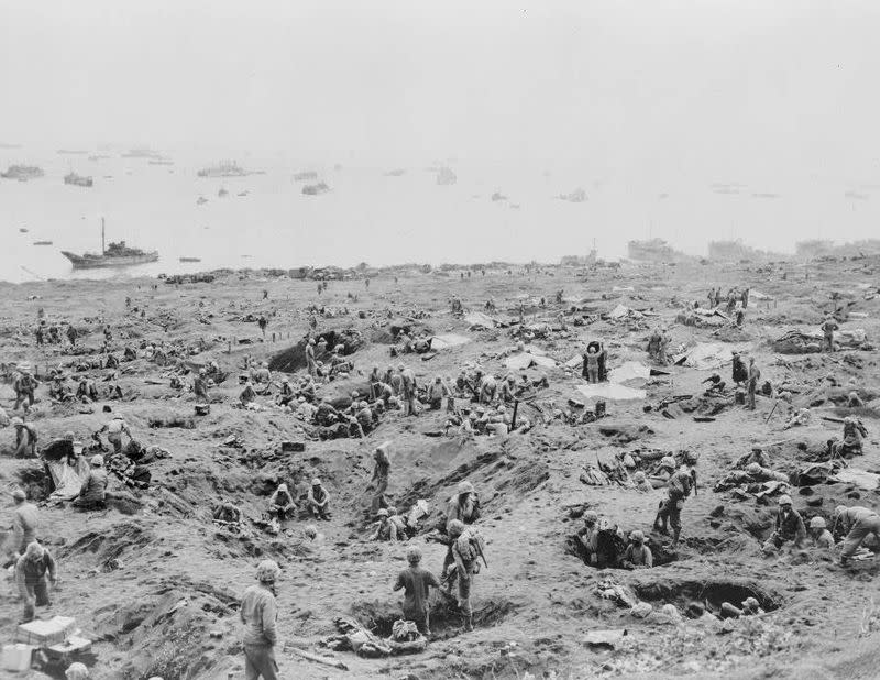 U.S. Marines covering the beach area at the southeast edge of Motoyama Airfield