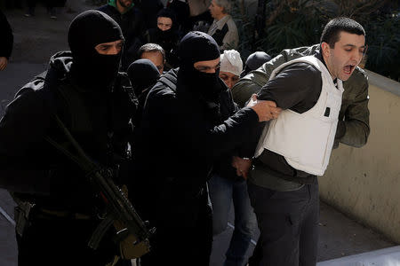 Eight men and a woman holding Turkish citizenship, who were arrested on suspected links to a leftist militant group outlawed in Turkey following an operation by Greek security services, are escorted by anti-terrorism police officers to the prosecutor's office in Athens, Greece, November 29, 2017. REUTERS/Alkis Konstantinidis