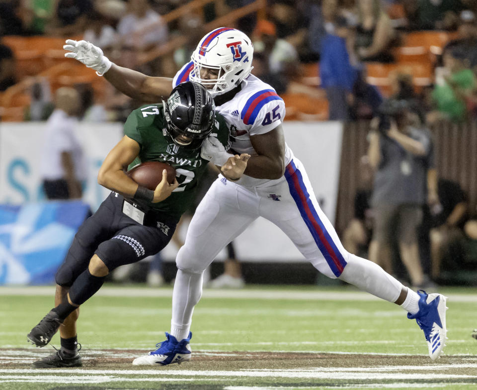 Louisiana Tech defensive end Jaylon Ferguson (45) sacks Hawaii quarterback Chevan Cordeiro (12) in the first half of the Hawaii Bowl NCAA college football game, Saturday, Dec. 22, 2018, in Honolulu. (AP Photo/Eugene Tanner)