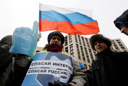 People attend a rally to protest against tightening state control over internet in Moscow, Russia March 10, 2019. The banner reads: "Save Internet, Save Russia ". REUTERS/Shamil Zhumatov