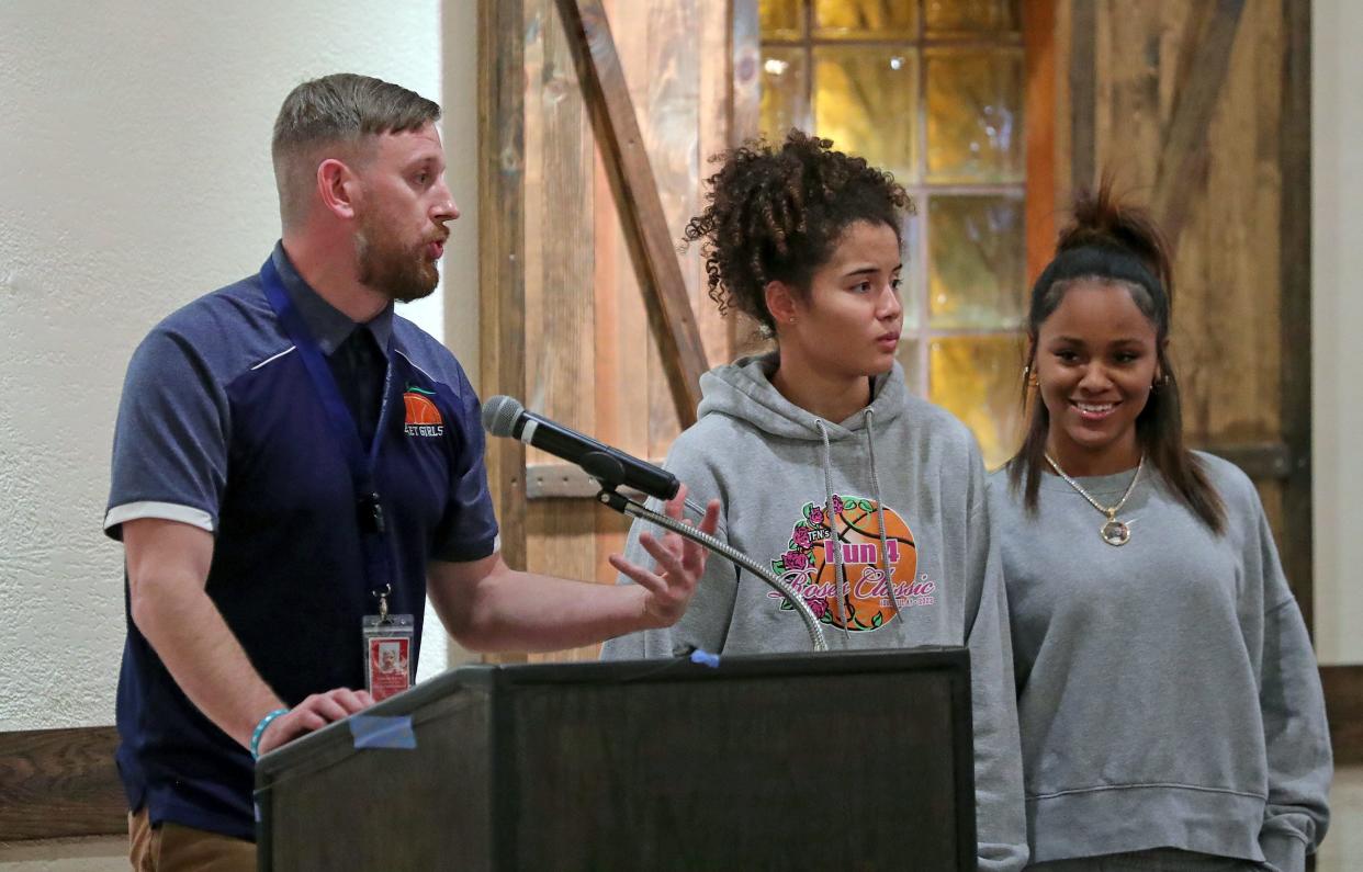 Ellet girls basketball coach Nick Harris, left, introduces Caitlyn Holmes and Jaeda Tavares during the Akron City Series high school basketball media day at Guy's Party Center on Tuesday in Akron.