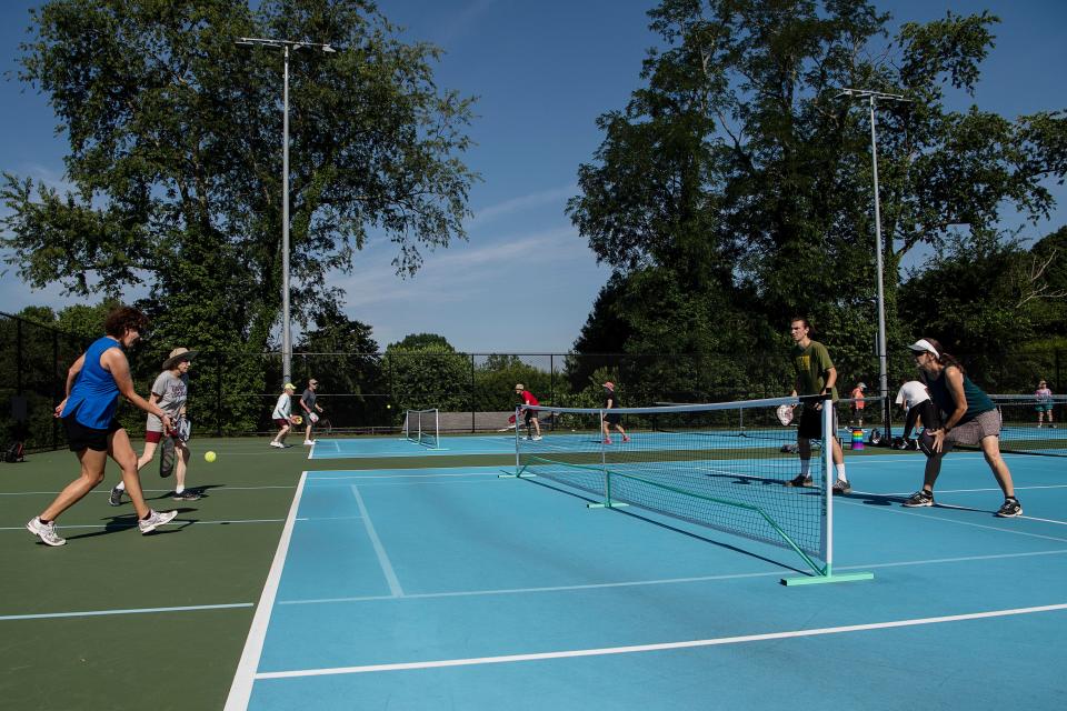 From left, Melinda Splain, Donna Kelly, Graham Gutekanst and Rachel Friel play pickleball together at Murphy-Oakley Park June 17, 2022.