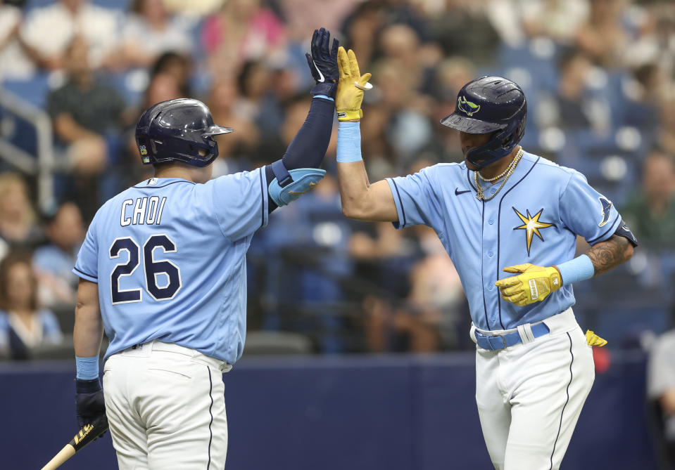 Tampa Bay Rays' Jose Siri , right, celebrates with teammate Ji-Man Choi (26) after hitting a solo home run in the second inning of a baseball game against the Texas Rangers, Sunday, Sept. 18, 2022, in St. Petersburg, Fla. (AP Photo/Mark LoMoglio)