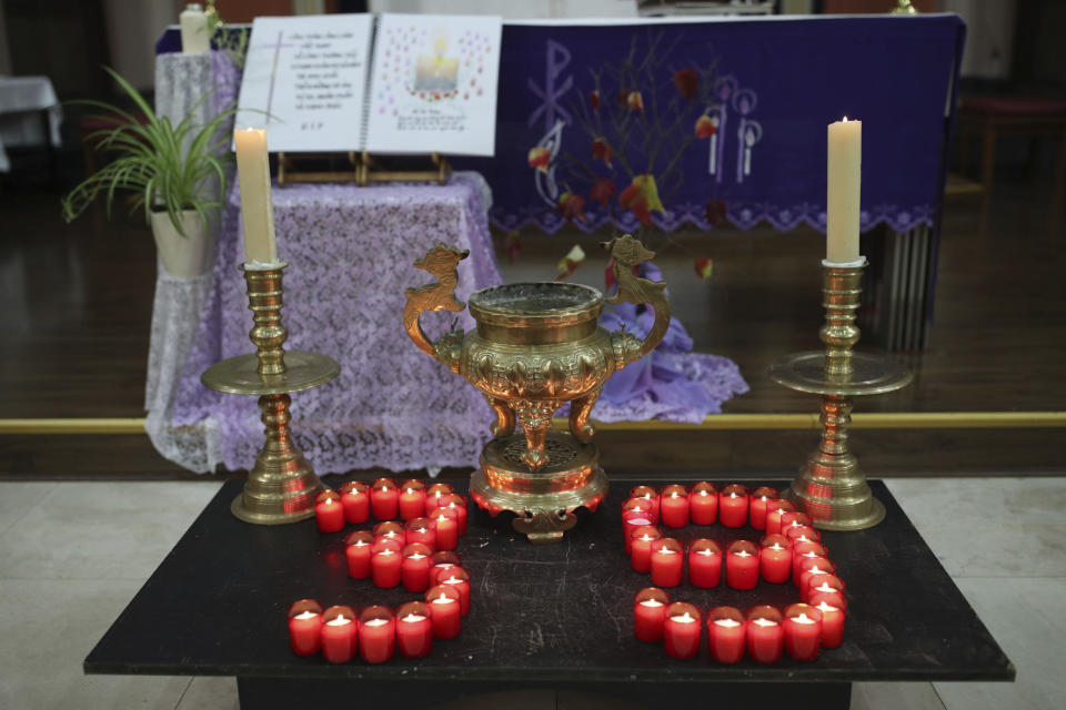 Candles are arranged in a "39" during a Mass and vigil for the 39 victims found dead inside the back of a truck in Grays, Essex, at The Holy Name and Our Lady of the Sacred Heart Church, east London's Vietnamese church on Saturday, Nov. 2, 2019. All those killed were Vietnamese nationals, British police said. (Yui Mok/PA via AP)