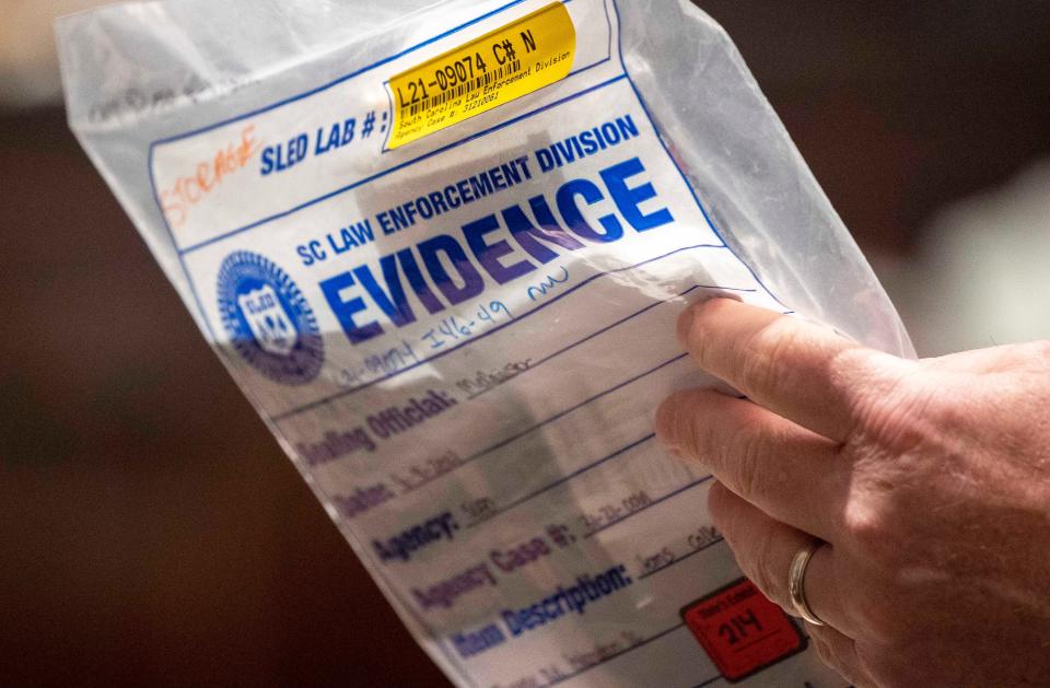 Jan 31, 2023; Walterboro, SC, USA; Defense attorney Jim Griffin holds up evidence in the double murder trial of Alex Murdaugh at the Colleton County Courthouse in Walterboro, Tuesday, Jan. 31, 2023.  Mandatory Credit: Andrew J. Whitaker/Pool via USA TODAY NETWORK