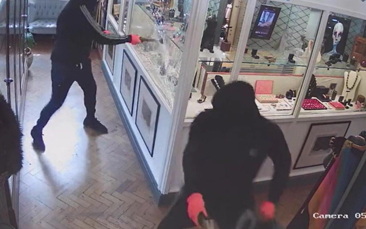 Robbers stole jewellery worth thousands of pounds after smashing their way into a reinforced glass cabinet