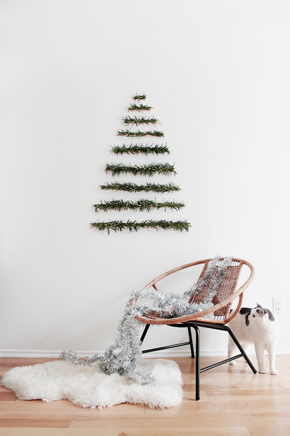 <p>Searching for a minimalist take on an alternative Christmas tree? Look no further than this simple, yet beautiful, creation that can be showcased on a wall. </p><p><strong>Get the tutorial at <a href="http://almostmakesperfect.com/2014/12/03/diy-makeshift-xmas-tree-wall-hanging/" rel="nofollow noopener" target="_blank" data-ylk="slk:Almost Makes Perfect" class="link rapid-noclick-resp">Almost Makes Perfect</a>.</strong></p><p><a class="link rapid-noclick-resp" href="https://www.amazon.com/Cobiz-Premium-Sticks-Christmas-Decoration/dp/B0721PTD5B/ref=sr_1_4?tag=syn-yahoo-20&ascsubtag=%5Bartid%7C10050.g.28872053%5Bsrc%7Cyahoo-us" rel="nofollow noopener" target="_blank" data-ylk="slk:SHOP HOT GLUE GUNS">SHOP HOT GLUE GUNS</a></p>