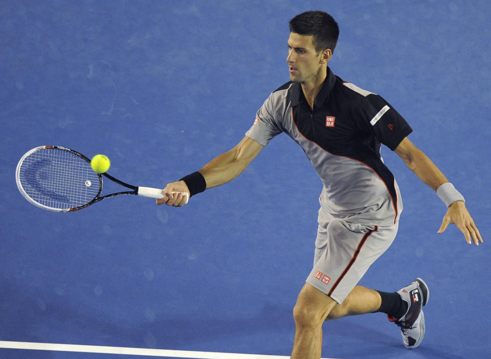 Novak Djokovic of Serbia makes a forehand return to Denis Istomin of Uzbekistan during their third round match at the Australian Open tennis championship in Melbourne, Australia, Friday, Jan. 17, 2014.(AP Photo/Andrew Brownbill)