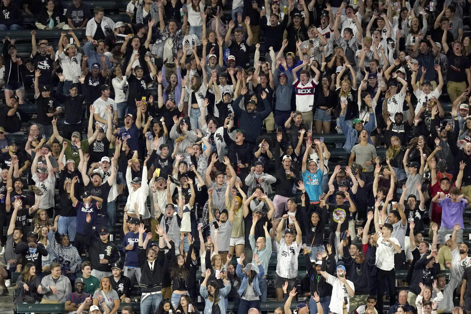 Fans do the wave in the left field bleachers during the eighth inning of a baseball game between the Chicago White Sox and the Tampa Bay Rays on Tuesday, June 15, 2021, in Chicago. Guaranteed Rate Field is scheduled to return to full capacity June 25. (AP Photo/Charles Rex Arbogast)