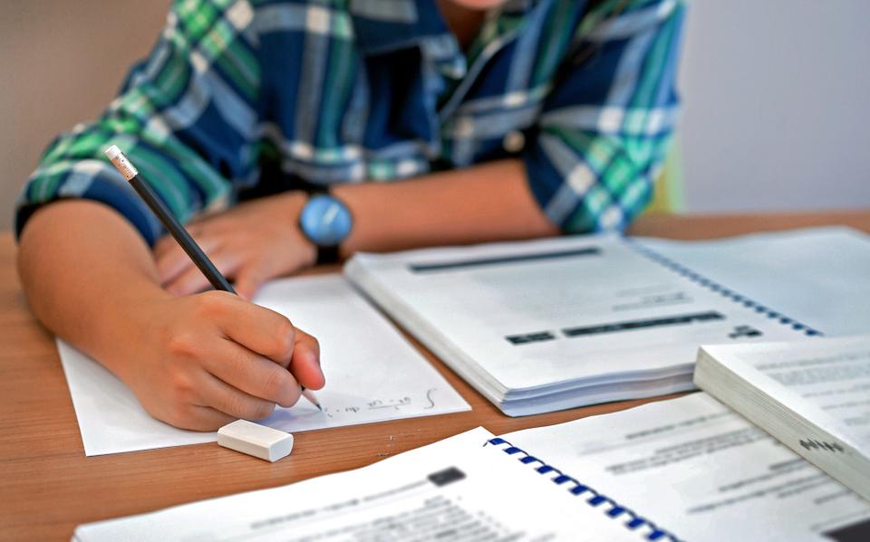 A young student works on calculus schoolwork.