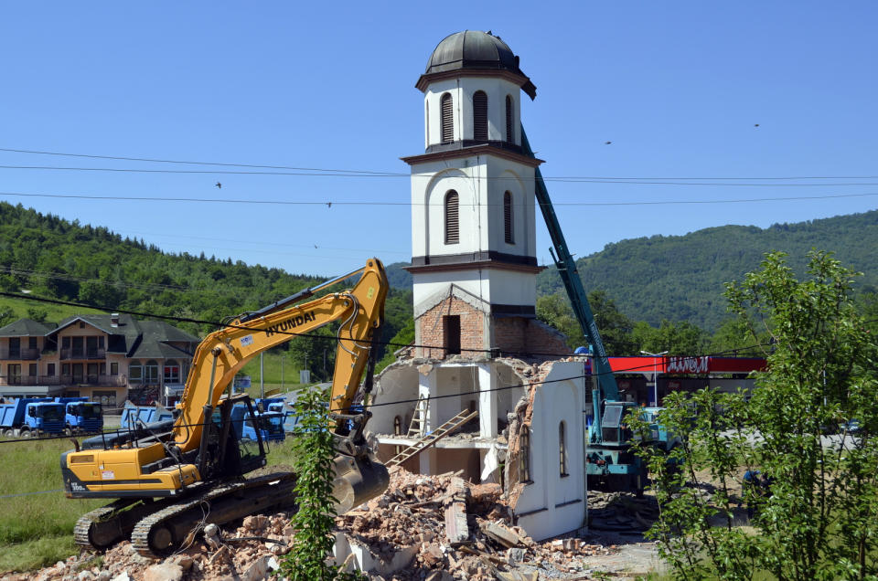 An orthodox church is demolished in Konjevic Polje, the village next to Srebrenica in Bosnia, Saturday, June 5, 2021. Bosnian authorities have demolished a Serbian Orthodox church illegally built on the land owned by a Bosniak woman after a 20-year-long legal battle that reached the European Court of Human Rights. Workers and construction machinery arrived at Fata Orlovic’s yard in the village of Konjevic Polje early Saturday. (AP Photo/Sladjan Vasic)