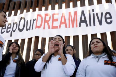 FILE PHOTO: 'Dreamers' react as they meet with relatives during the 'Keep Our Dream Alive' binational meeting at a new section of the border wall on the U.S.-Mexico border in Sunland Park, U.S., December 10, 2017. REUTERS/Jose Luis Gonzalez/File Photo