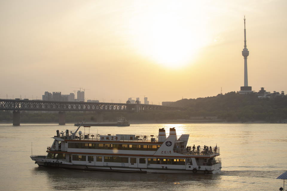 In this April 8, 2020, photo, a ferry crosses the Yangtze River in Wuhan in central China's Hubei province. The reopening of ferry service on the Yangtze River, the heart of life in Wuhan for more than 20 centuries, was an important symbolic step in official efforts to get business and daily life in this central Chinese city of 11 million people back to normal after a 76-day quarantine ended in the city at the center of the coronavirus pandemic. (AP Photo/Ng Han Guan)