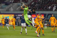 Goalkeeper Andries Noppert of the Netherlands, top left, defends a ball against Ecuador's Angelo Preciado during the World Cup group A soccer match between Netherlands and Ecuador, at the Khalifa International Stadium in Doha, Qatar, Friday, Nov. 25, 2022. (AP Photo/Themba Hadebe)