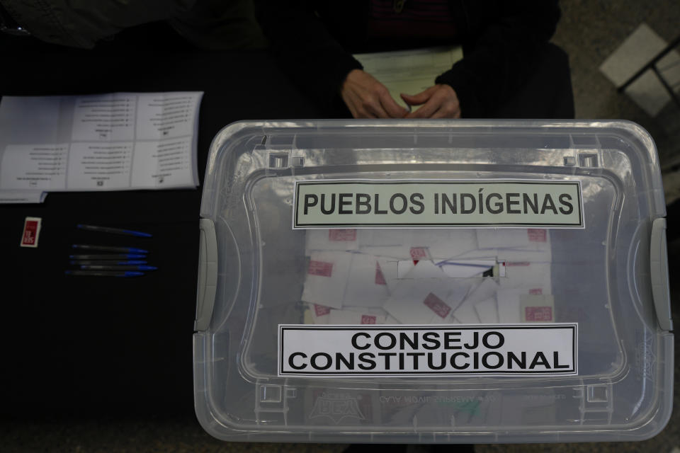 An electoral worker prepares an election box that reads in Spanish "Indigenous people," which is reserved for Indigenous people to vote for a representative in the upcoming Constitutional Council election in Santiago, Chile, Friday, May 5, 2023. The election will be held May 7, after a first attempt to replace the current Constitution bequeathed by the military 42 years ago was rejected by voters in 2022. (AP Photo/Esteban Felix)