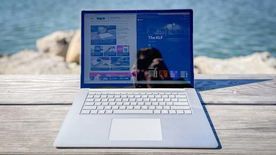 Surface Laptop 5 outdoors on patio table, websites on screen