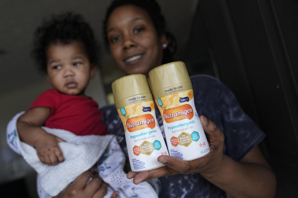 Ashley Yancey holds her 11 month-old daughter, Olivia, as she shows the last two cans of non dairy formula she has at home in Douglasville, Ga., on Dec. 14, 2023. The USDA started piloting online SNAP purchases in 2019 and expanded it during the pandemic. But unlike food stamps, WIC-approved items can’t be bought online. “It’s harder that I can’t get my milk like that,” she said. “I have to borrow somebody’s car to go look for the milk, just to not find the milk. It is inconvenient that they don’t take WIC online.” (AP Photo/John Bazemore)