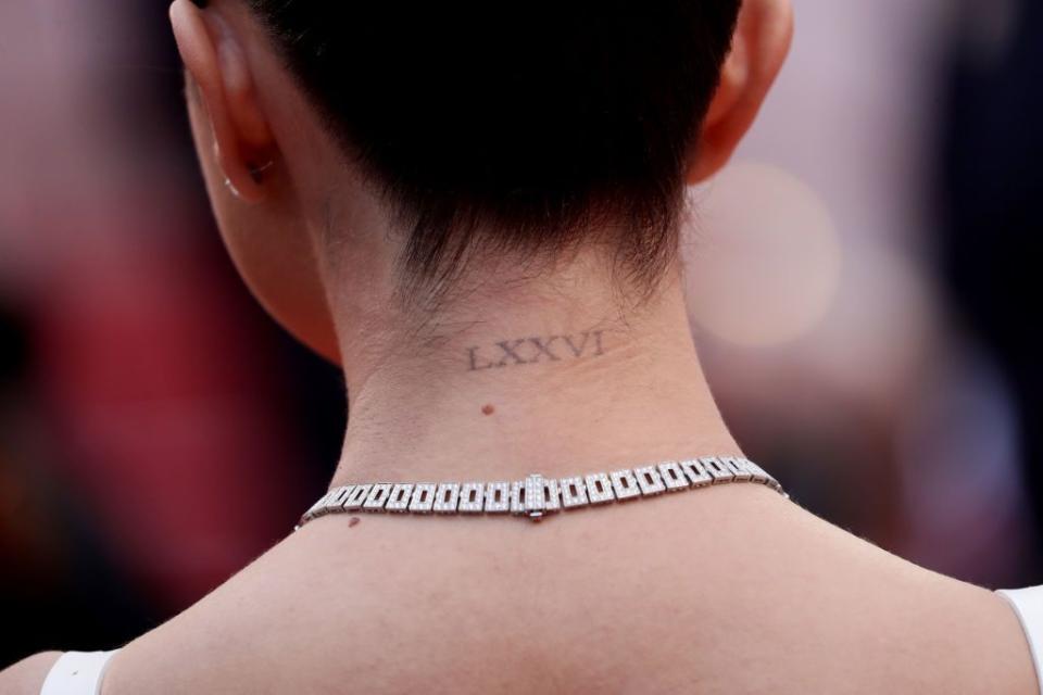 4) Selena Gomez Neck Tattoo: Roman Numerals