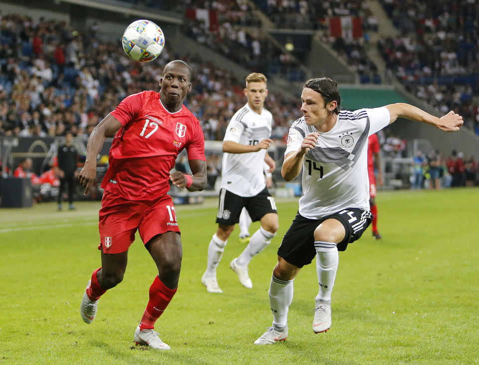 Germany's Nico Schulz, right, and Peru's Luis Jan Advincula fight for the ball during a friendly soccer match between Germany and Peru in Sinsheim, Germany, Sunday, Sept. 9, 2018. (AP Photo/Michael Probst)